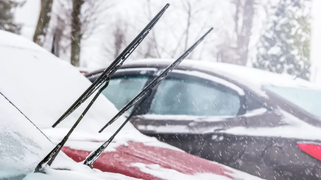cars parked outside in winter with windshield wipers up